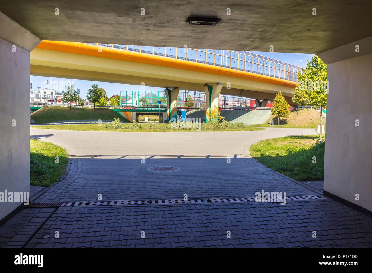 Highway, overpasses and concrete columns.Sound absorbing screens are metal frames filled with glass.View from the tunnel. Modern technology in Poland. Stock Photo
