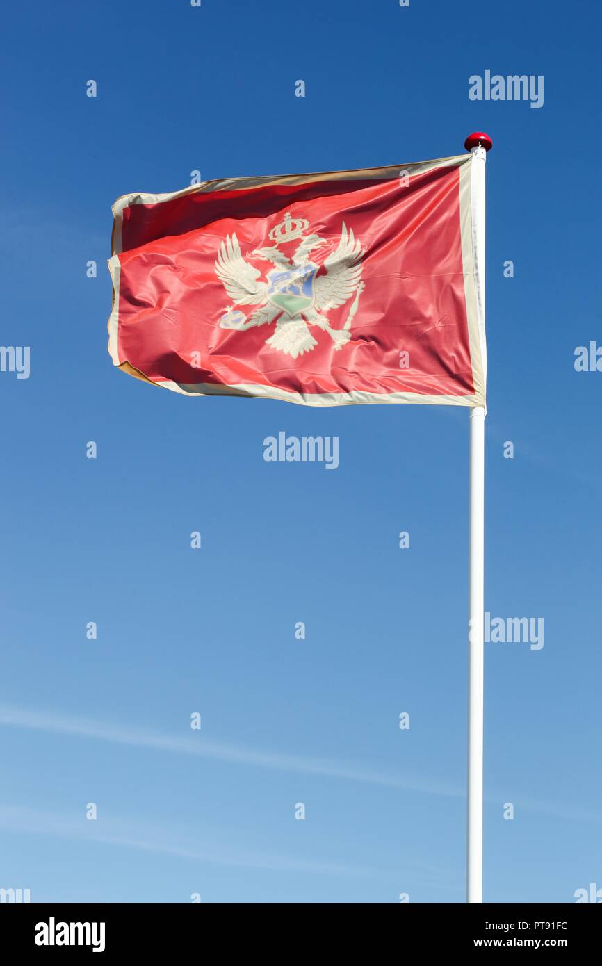 flag-of-montenegro-waving-in-the-sky-stock-photo-alamy