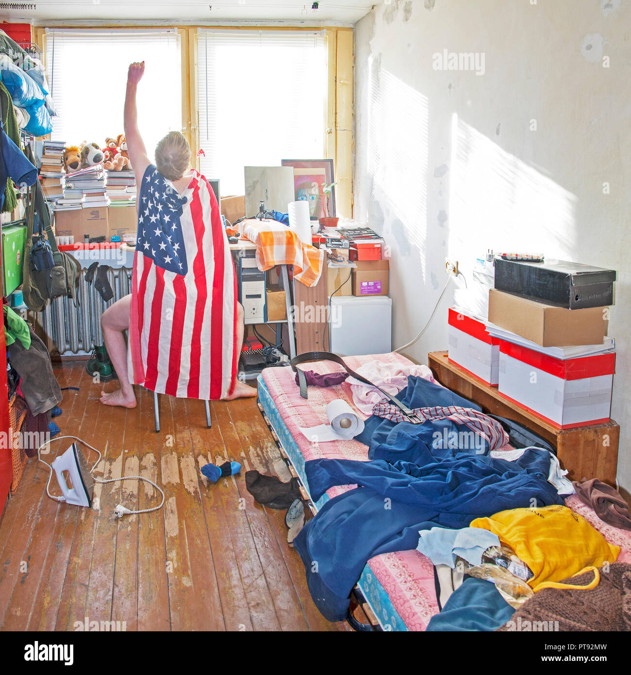 Messy superman's room. Piles of clothes, boxes, books Stock Photo