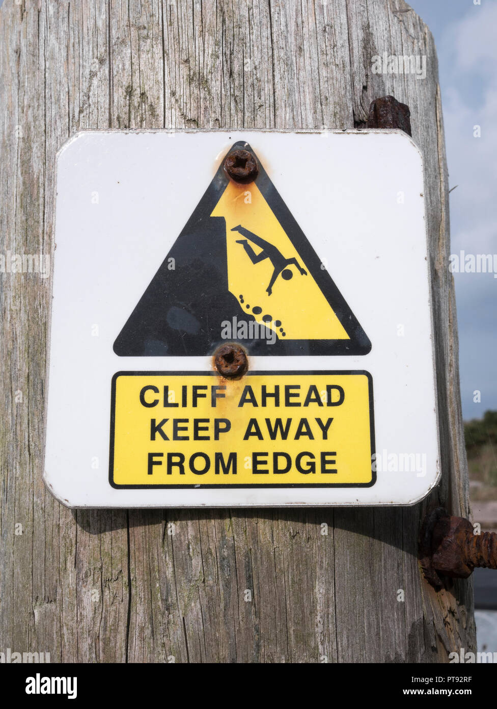 Cliff danger warning sign. Keep away from the cliff edge concept