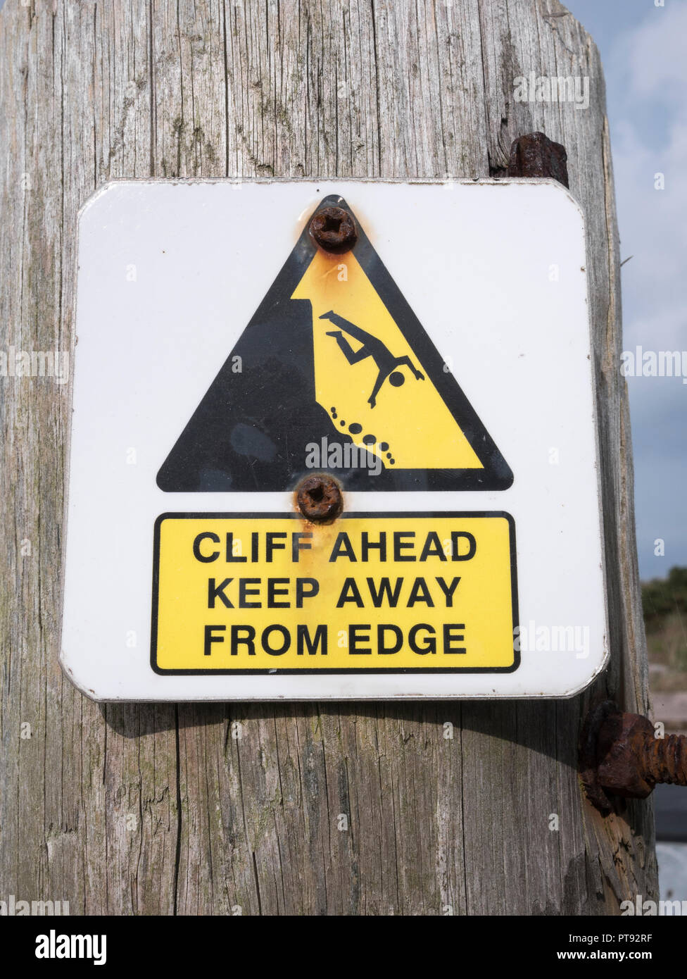 Cliff danger warning sign. Keep away from the cliff edge concept, falling off, falling man pictogram. Stock Photo