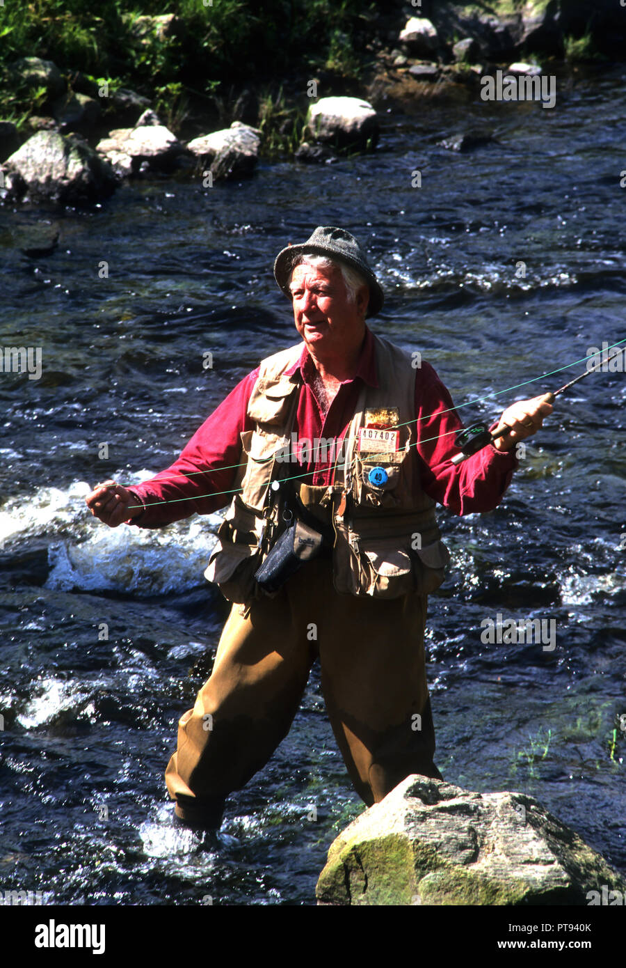 A flyfisherman works a stream in Massachusetts, USA Stock Photo