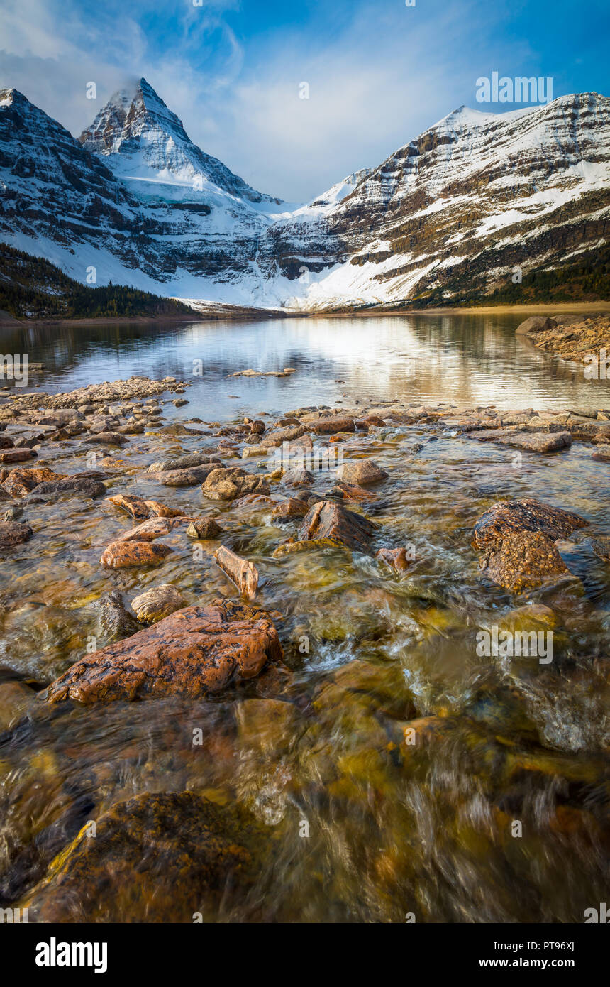 Mount Assiniboine, also known as Assiniboine Mountain, is a pyramidal peak mountain located on the Great Divide, in British Columbia. Stock Photo