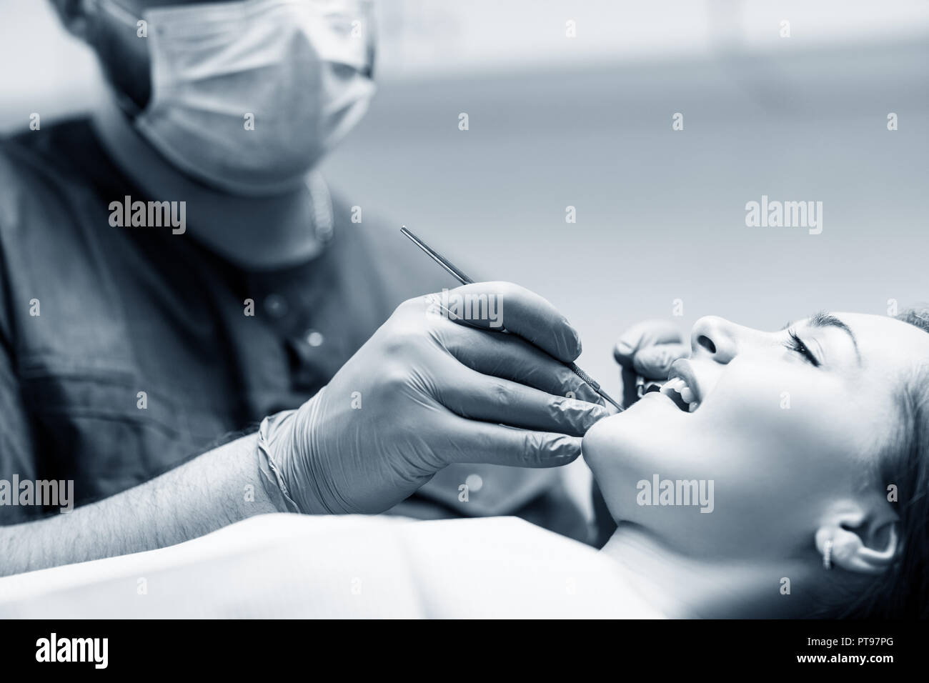 Dentist checkup teeth to young woman patient in clinic Stock Photo Alamy