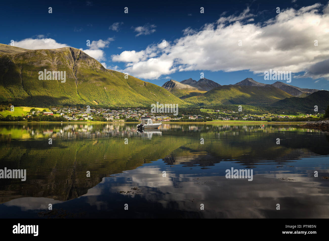 View on Isfjorden and distant mountains. Beautiful reflections in still water surface. Stock Photo