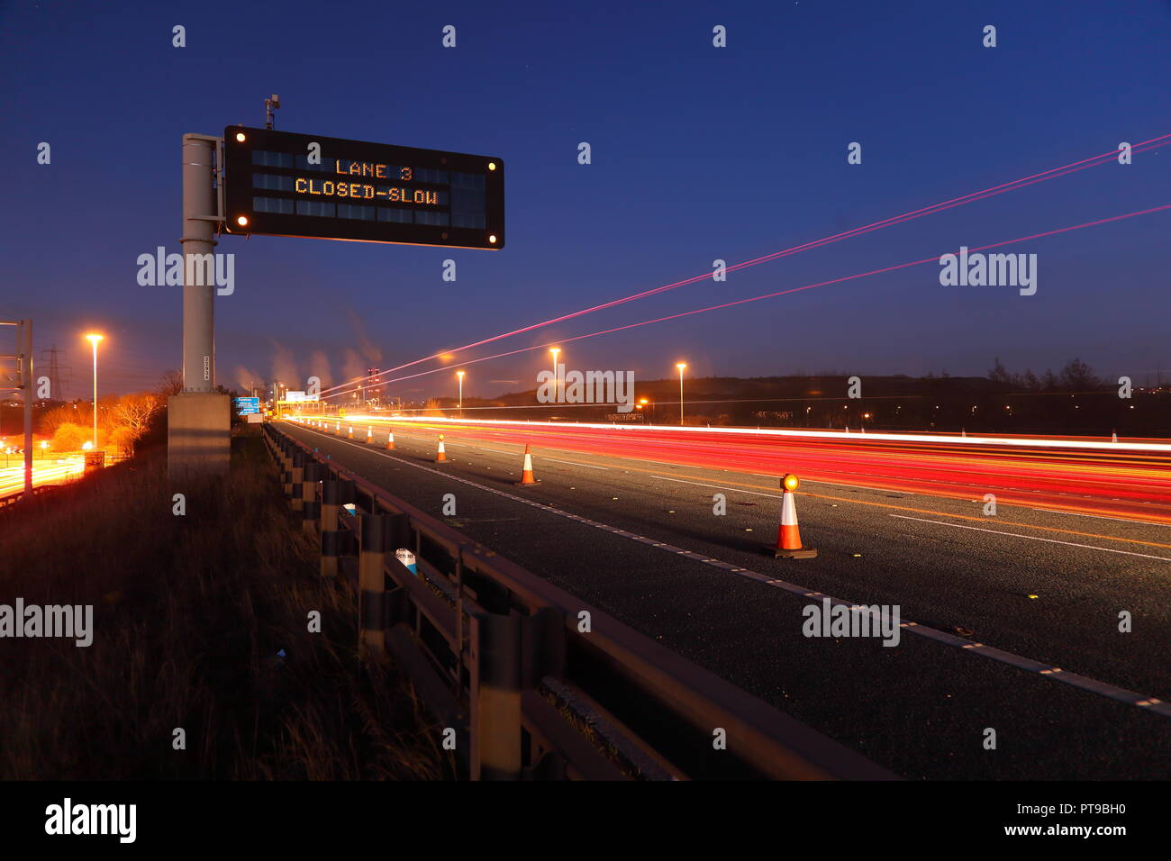 A motorway matrix sign warning motorists of a lane closure due to an incident in the central reservation on the M62 at Pontefract,West Yorkshire,UK Stock Photo
