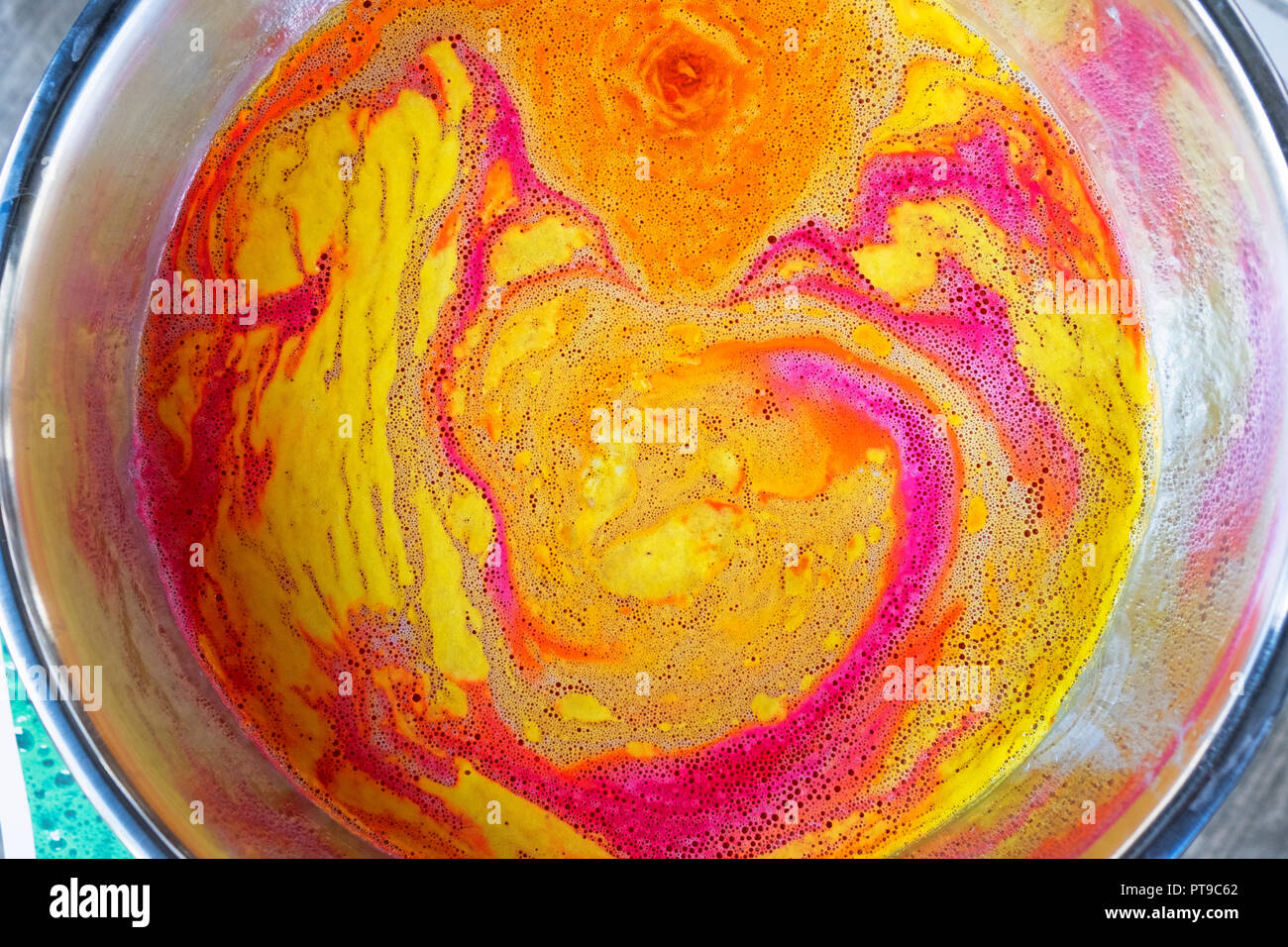 A colorful abstract pattern in a sink formed by putting Lush soap in running water. Outside a Lush store on East 14th Street in Manhattan, New York. Stock Photo