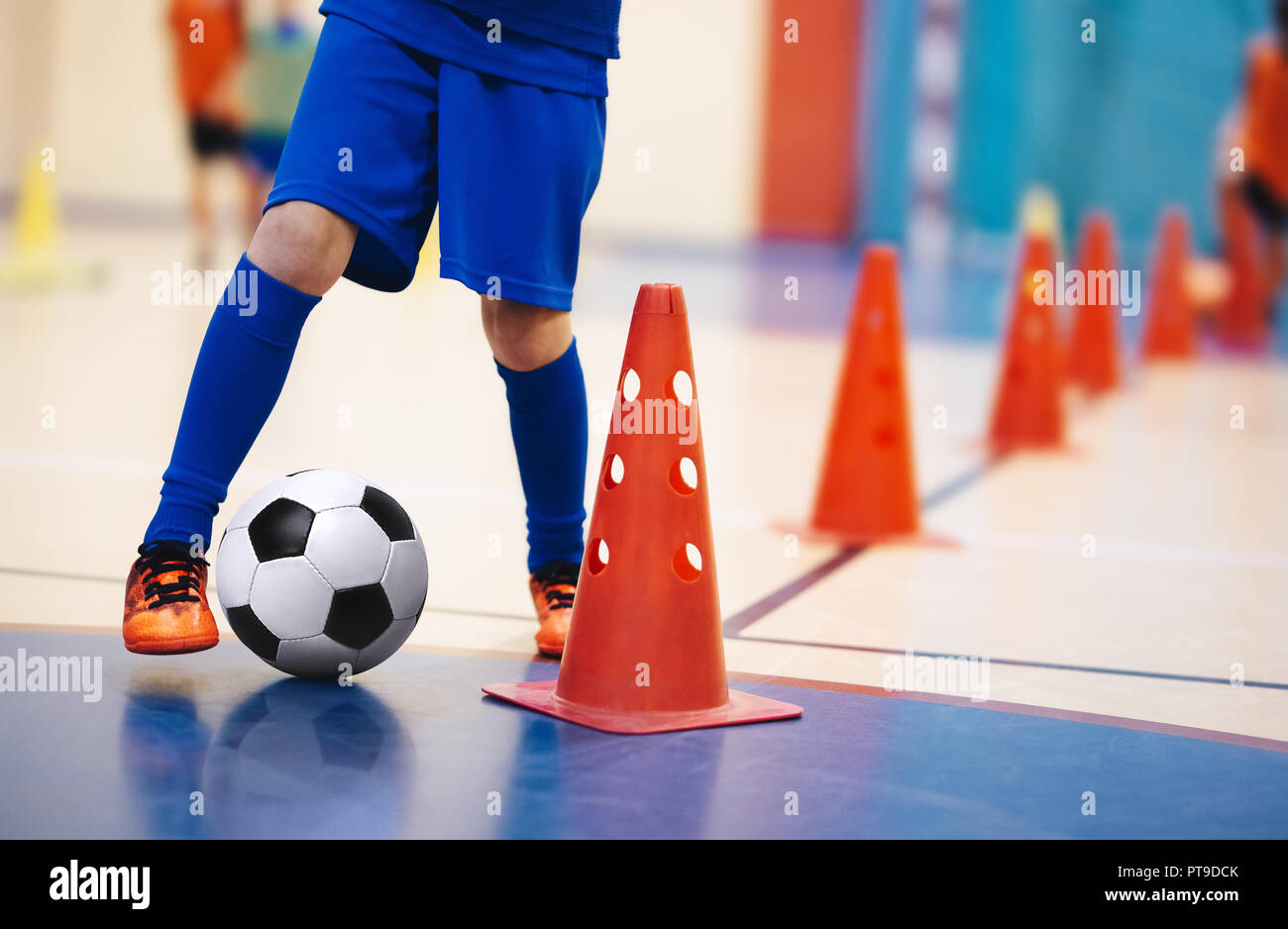 Indoor soccer players training with balls. Indoor soccer sports hall
