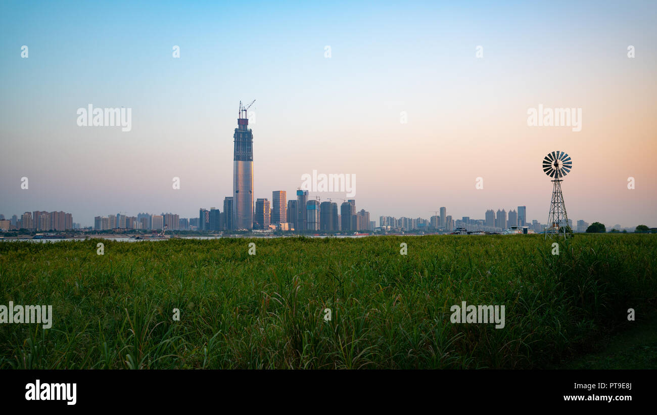 Sunset panorama of Wuhan Wuchang skyline and Hankou Yangtze riverside marshland park in Wuhan Hubei China Stock Photo