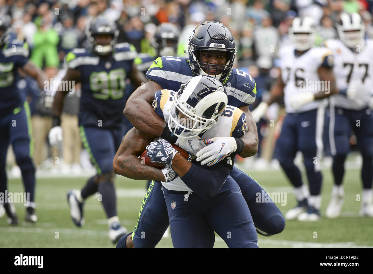 Seattle, Washington, USA. 7th Oct, 2018. The Rams GERALD EVERETT (81) is tackled by BARKEVIOUS MINGO (51) as the Los Angeles Rams beat the Seattle Seahawks 33-31 in a NFC West game at Century Link Field in Seattle, WA. Credit: Jeff Halstead/ZUMA Wire/Alamy Live News Stock Photo