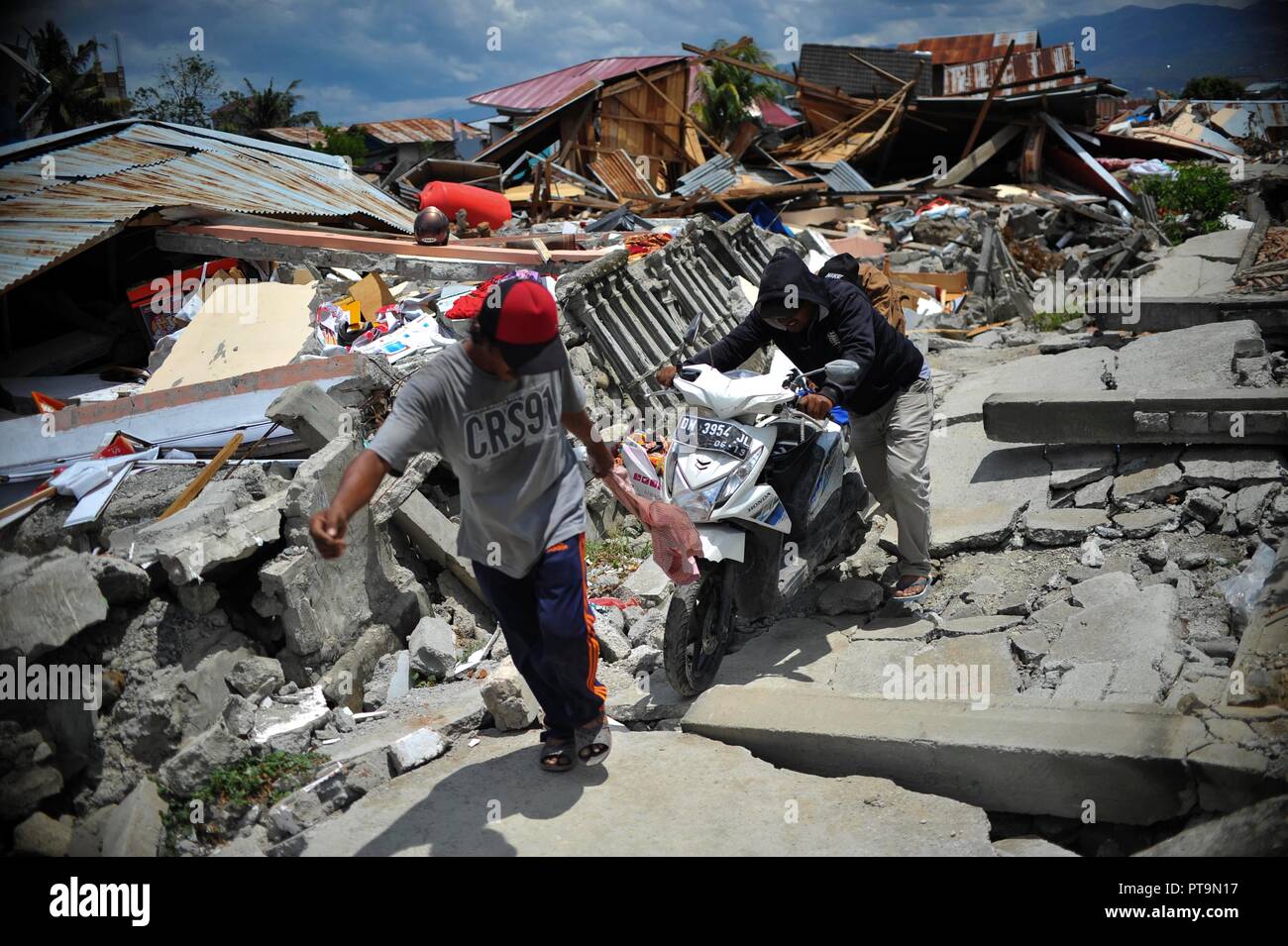 Poso Indonesia 8th Oct 18 Villagers Push A Motorcycle On The Ruins Of Houses In Poso Poso Indonesia 8th Oct 18 Villagers Push A Motorcycle On The Ruins Of Houses In Poso