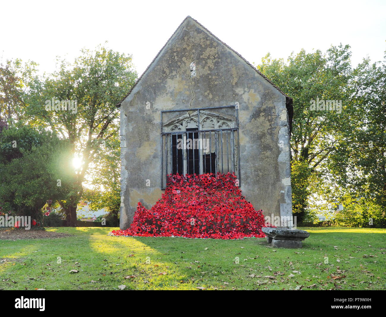 Murston, Kent, UK. 8th Oct, 2018. UK Weather: the sun sets behind Murston Old Church, which has been decorated with thousands of poppies by the Murston HeArt Poppy Project 2018  to commemorate the WW1 Centenary 2018. Murston HeArt Project and Swale in Bloom have been working with the people of Swale and have made over 3000 unique poppies that now represent one of over 3000 fallen heroes from across the Swale area that died in World War One. Credit: James Bell/Alamy Live News Stock Photo
