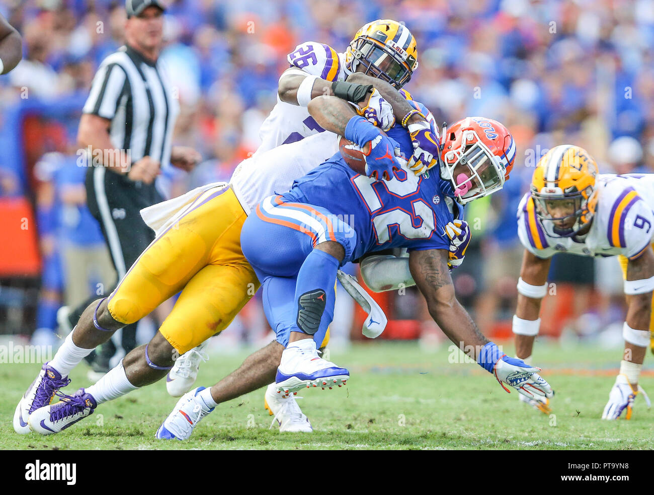 Oct 6 - Gainesville, FL, U.S.: LSU Tigers safety John Battle (26) tackles Florida Gators running back Lamical Perine (22) during the second half of NCAA football action at University of Florida. (Gary Lloyd McCullough/Cal Sport Media) Stock Photo