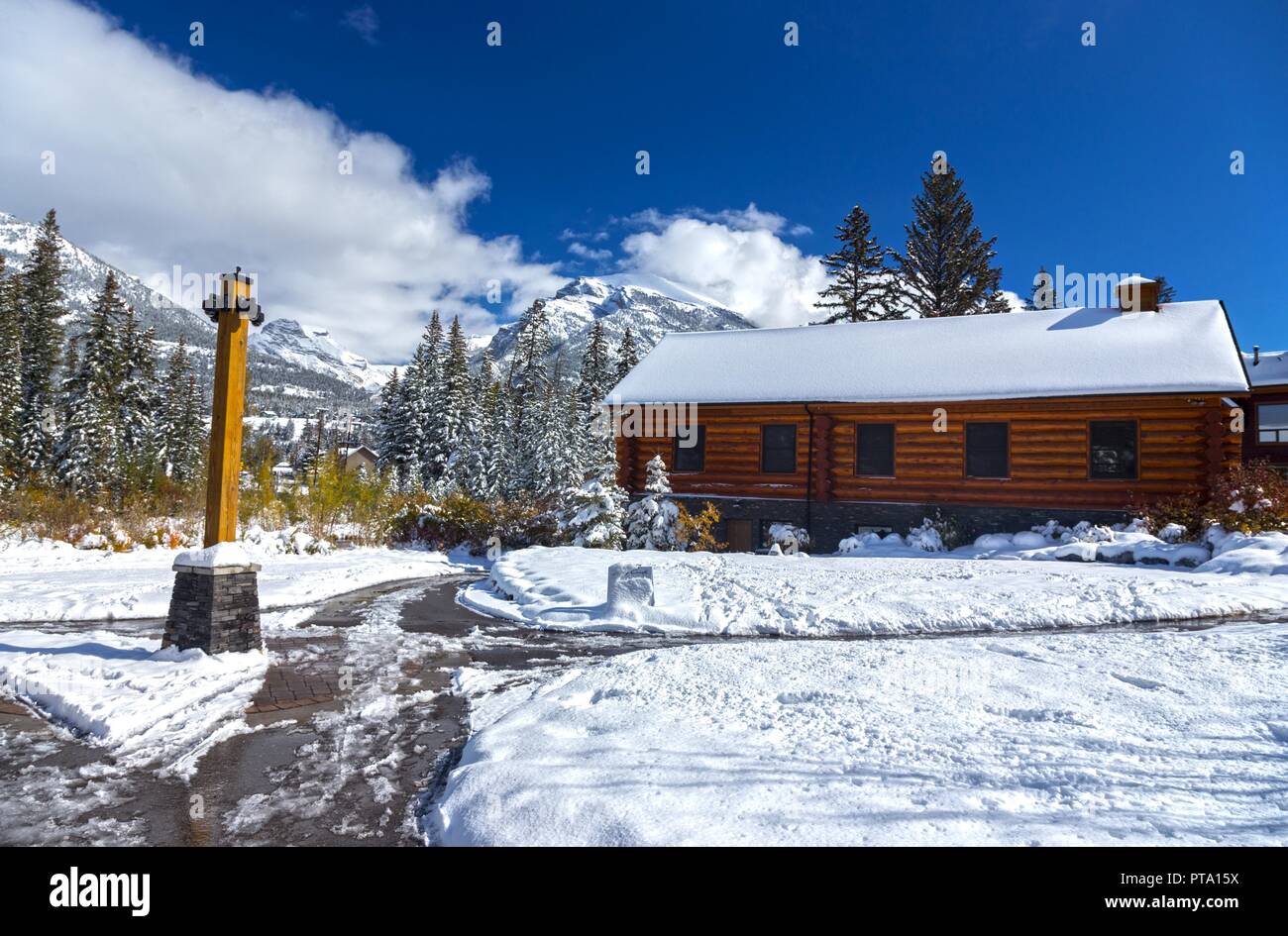 Wooden Log Cabin, Snowy Walking Paths Winter Landscape. Spring Creek