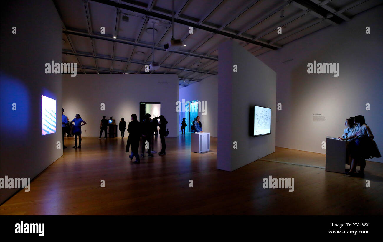 People interact with various artwork at the "Programmed" exhibit in the Whitney Museum of American Art in New York, NY (oct 2018) Stock Photo