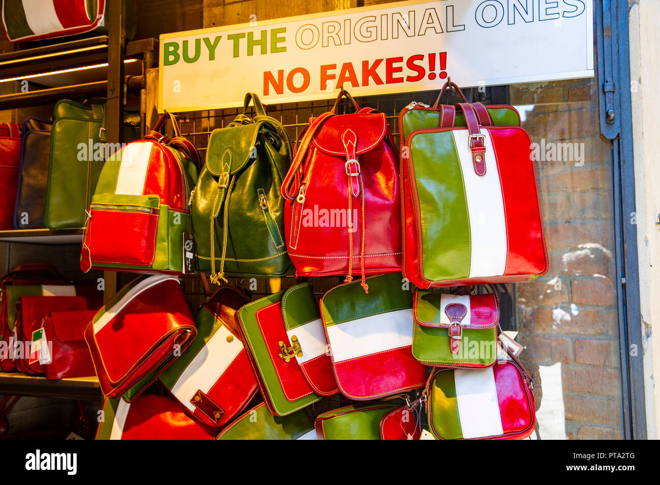 Original leather bags using italy national flag colours on sale in San Gimignano,Tuscany,Italy Stock Photo