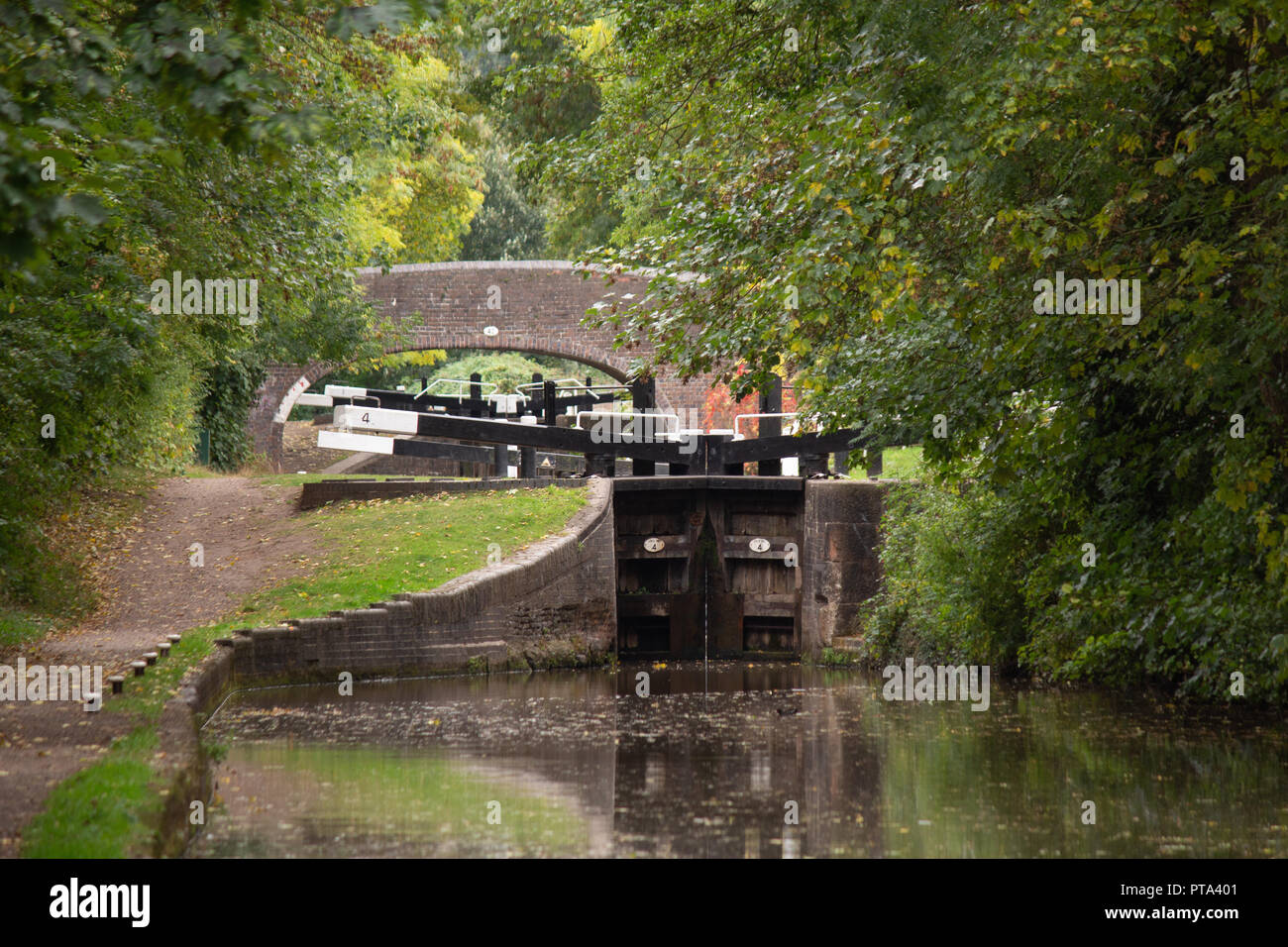 The Coventry canal in Atherstone, North Warwickshire, England. A lock and towpath near the Town Centre. Stock Photo