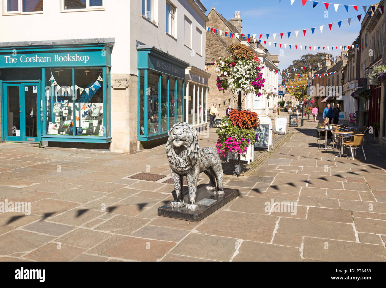 Lion sculpture in historic street and buildings in town centre of Corsham, Wiltshire, England, UK Stock Photo