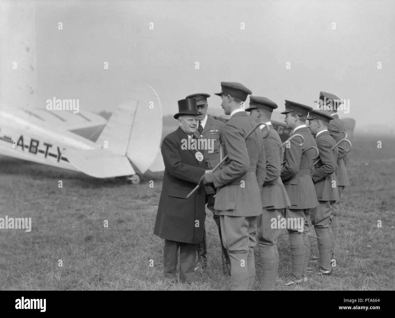 Visiting dignitary meeting airmen at Heston Aerodrome, Hounslow, London, c1933-c1935. Creator: Aerofilms. Stock Photo