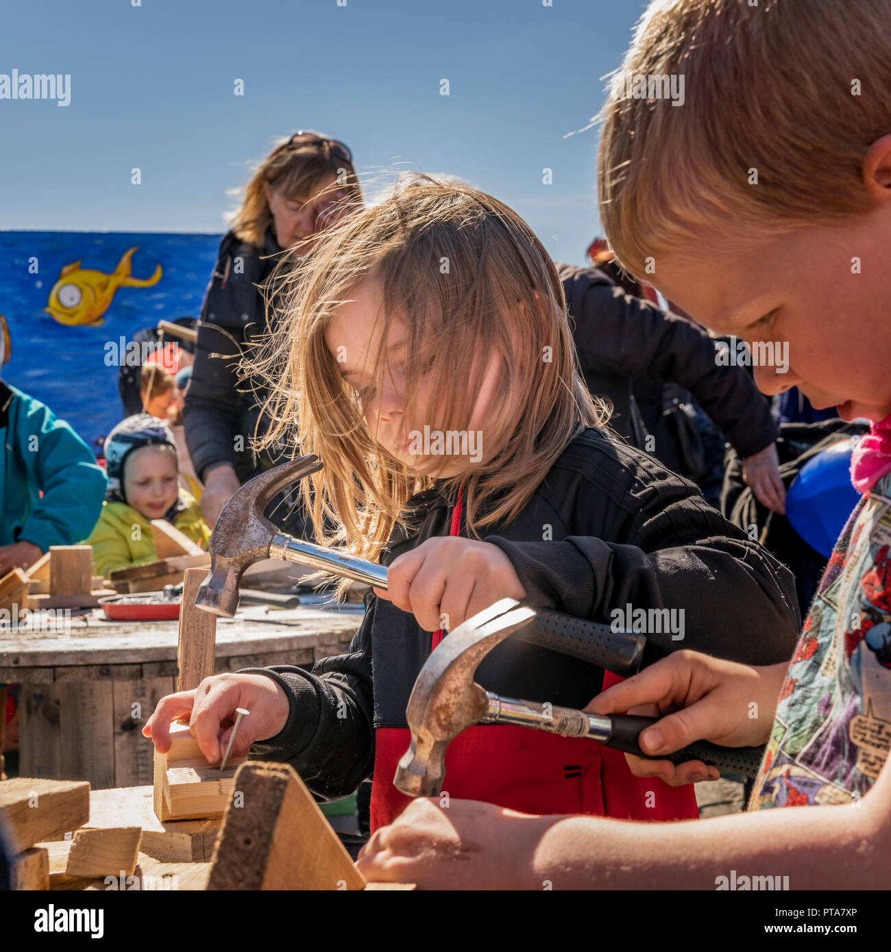 Children learning to use tools, Summer Festival, Seaman's Day, (Sjomannadagurinn) Reykjavik, Iceland Stock Photo