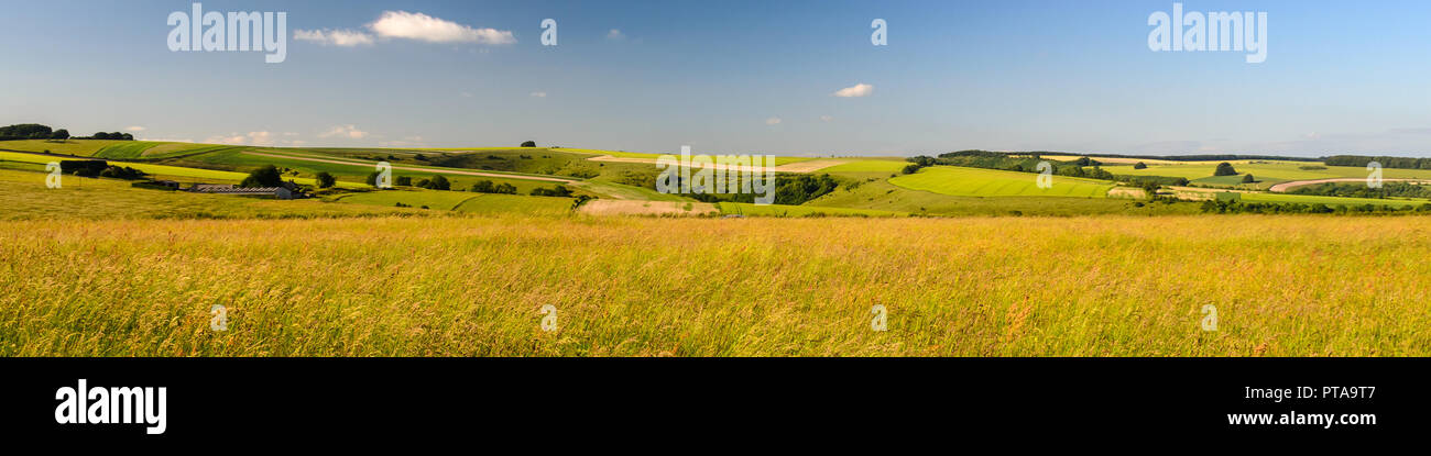 A patchwork of farmland fields and small woodland covers the rolling landscape of Cranborne Chase at Tollard Royal on the border of Wiltshire and Dors Stock Photo
