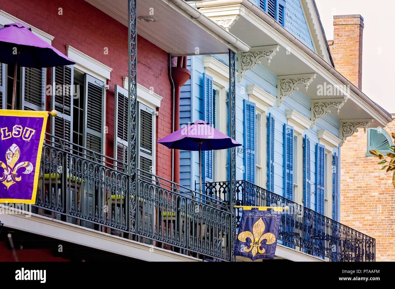 LSU and Who Dat Nation flags fly on the balcony in the French Quarter, November 11, 2015, in New Orleans, Louisiana. Stock Photo