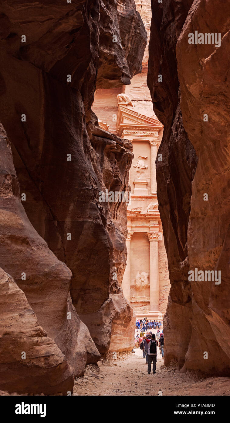 the treasury as it first appears when walking through the narrow siq canyon at petra in jordan Stock Photo