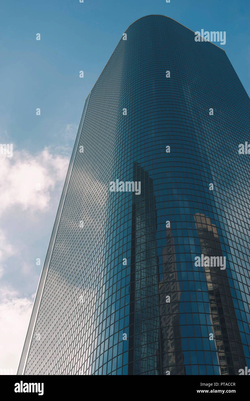 Tall sky scraper made of glass with sky and clouds Stock Photo