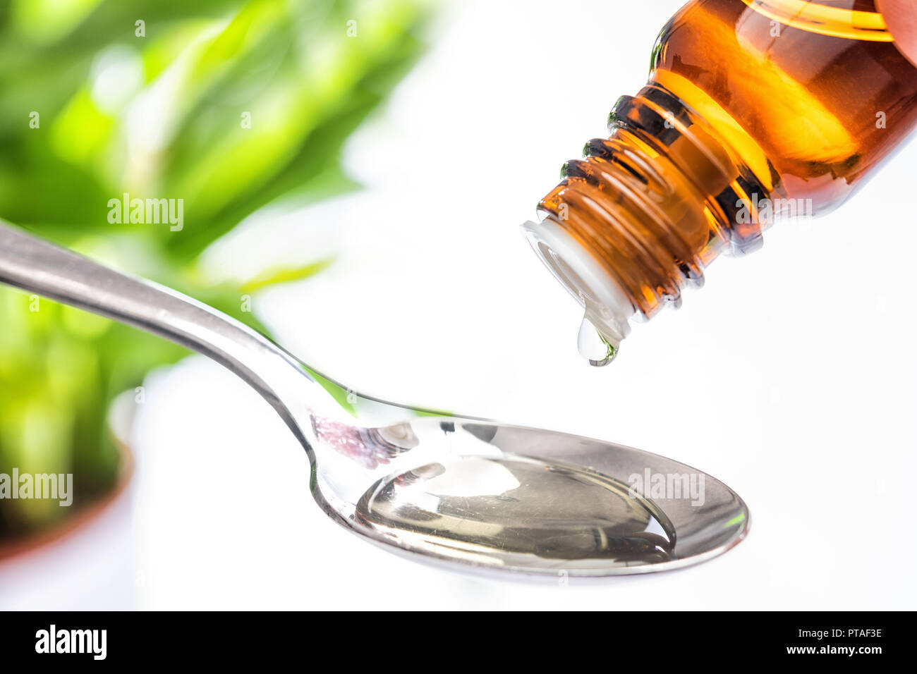 Medicine drops with spoon Stock Photo
