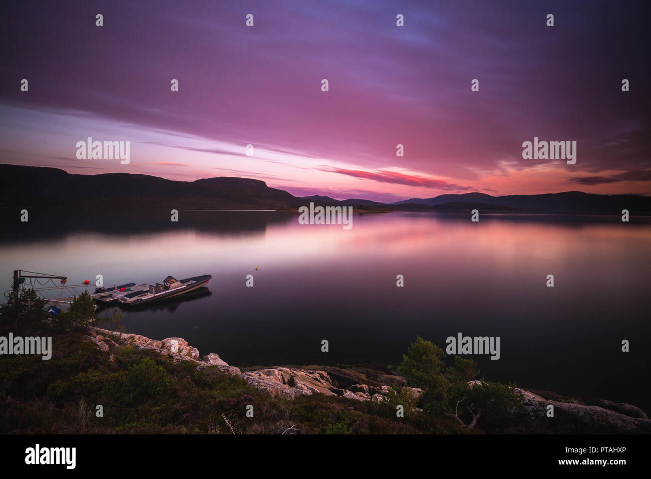 Long exposure time on sunset sky above sea bay called Gjerdavika near Lesund town, middle Norway. Stock Photo