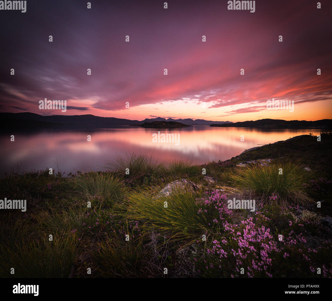 Long exposure time on sunset sky above sea bay called Gjerdavika near Lesund town, middle Norway. Stock Photo