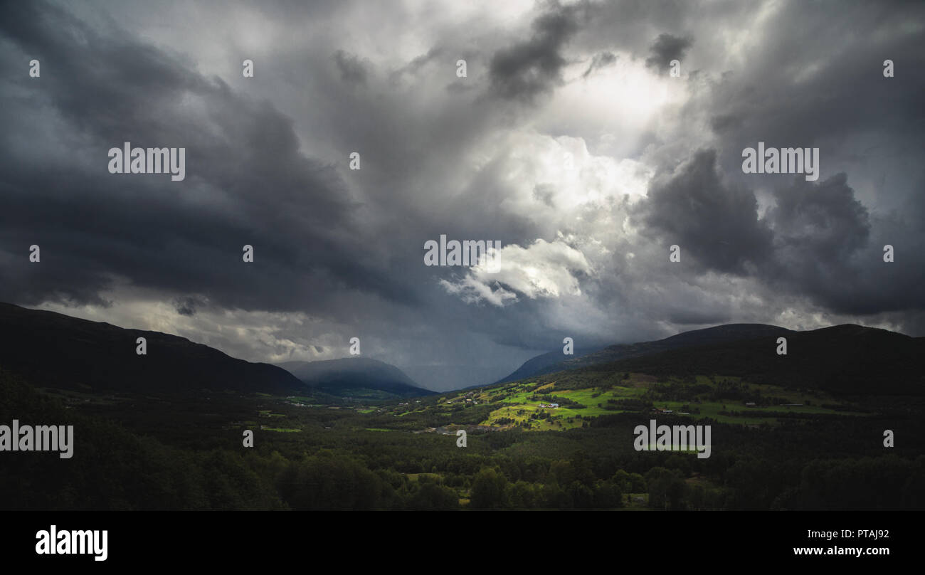 View on incoming heavy clouds above Trollheimen mountains, Oppdal area, Norway Stock Photo