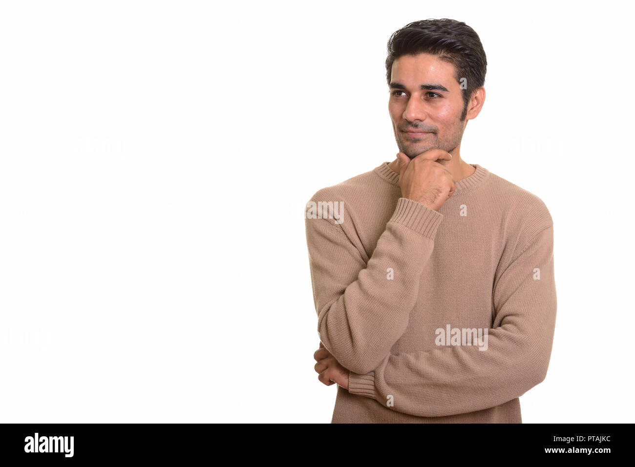 Young handsome Persian man against white background Stock Photo