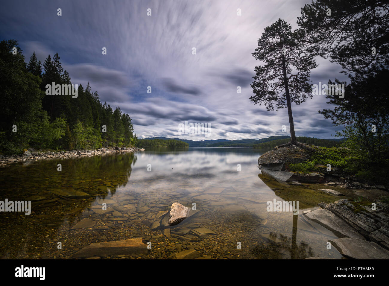 The shores of Jonsvatnet lake in long time exposure technique. Summer in Norway. Stock Photo
