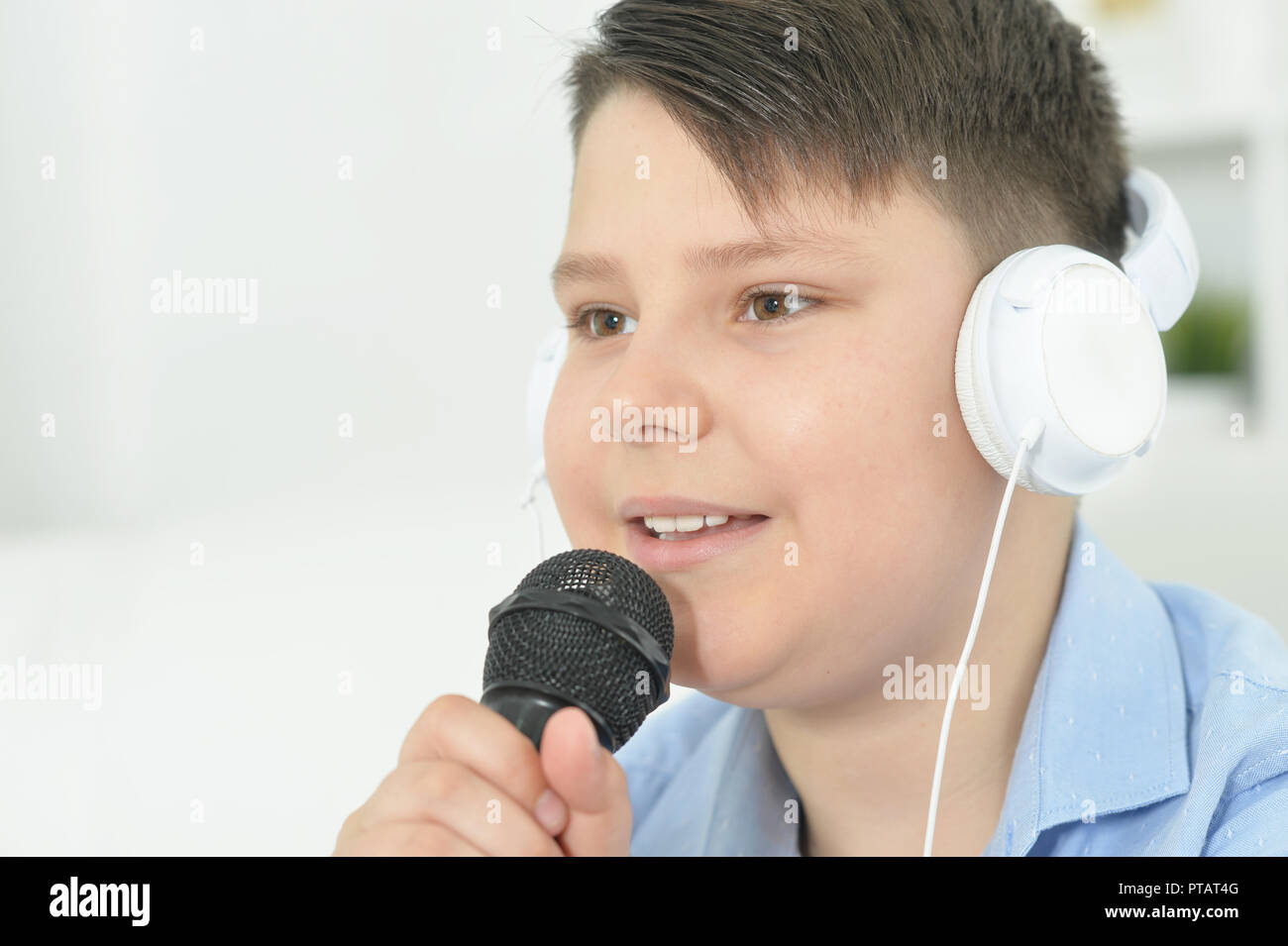 Portrait of a boy with microphone singing at home Stock Photo Alamy