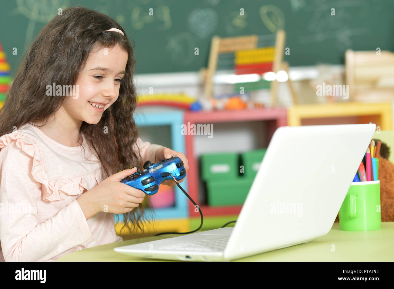 Portrait of a little girl using modern laptop Stock Photo - Alamy
