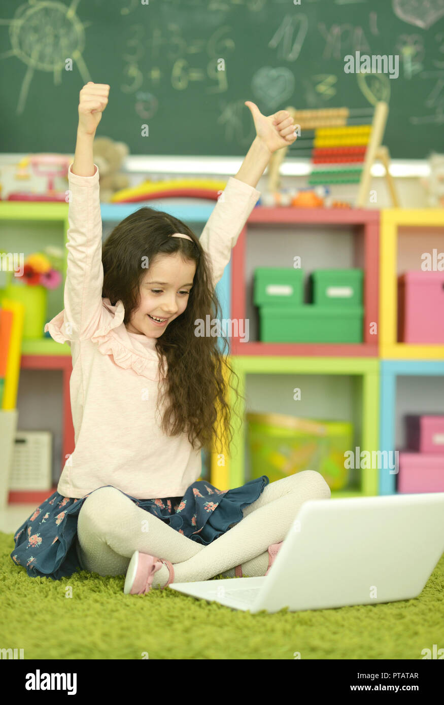 Portrait of emotional cute girl using laptop Stock Photo - Alamy