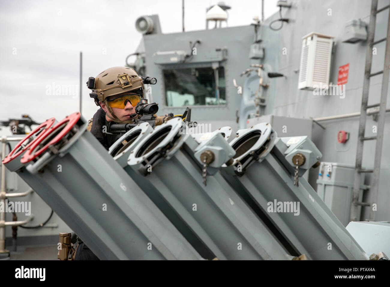 Royal Marines commandos perform a raid on a ship watched by Defence Secretary Gavin Williamson during a visit to HMS Montrose at HMNB Devonport, Plymouth. Stock Photo