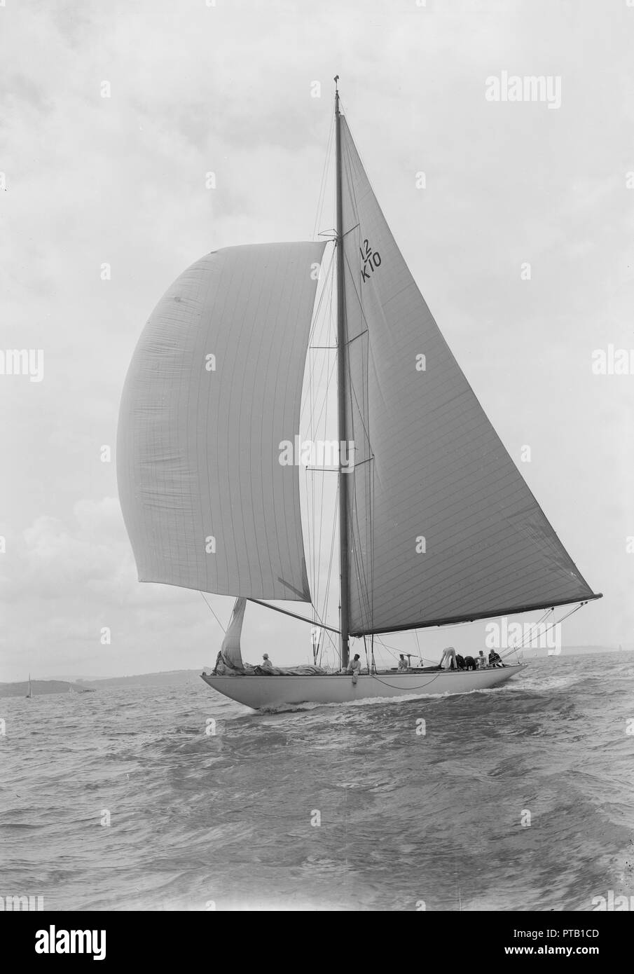 Sailing yacht 'Trivia' running downwind under spinnaker, 1939. Creator: Kirk & Sons of Cowes. Stock Photo