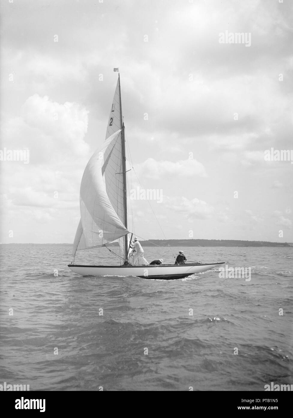 The 6 Metre class 'Cynthia' setting spinnaker, 1912. Creator: Kirk & Sons of Cowes. Stock Photo