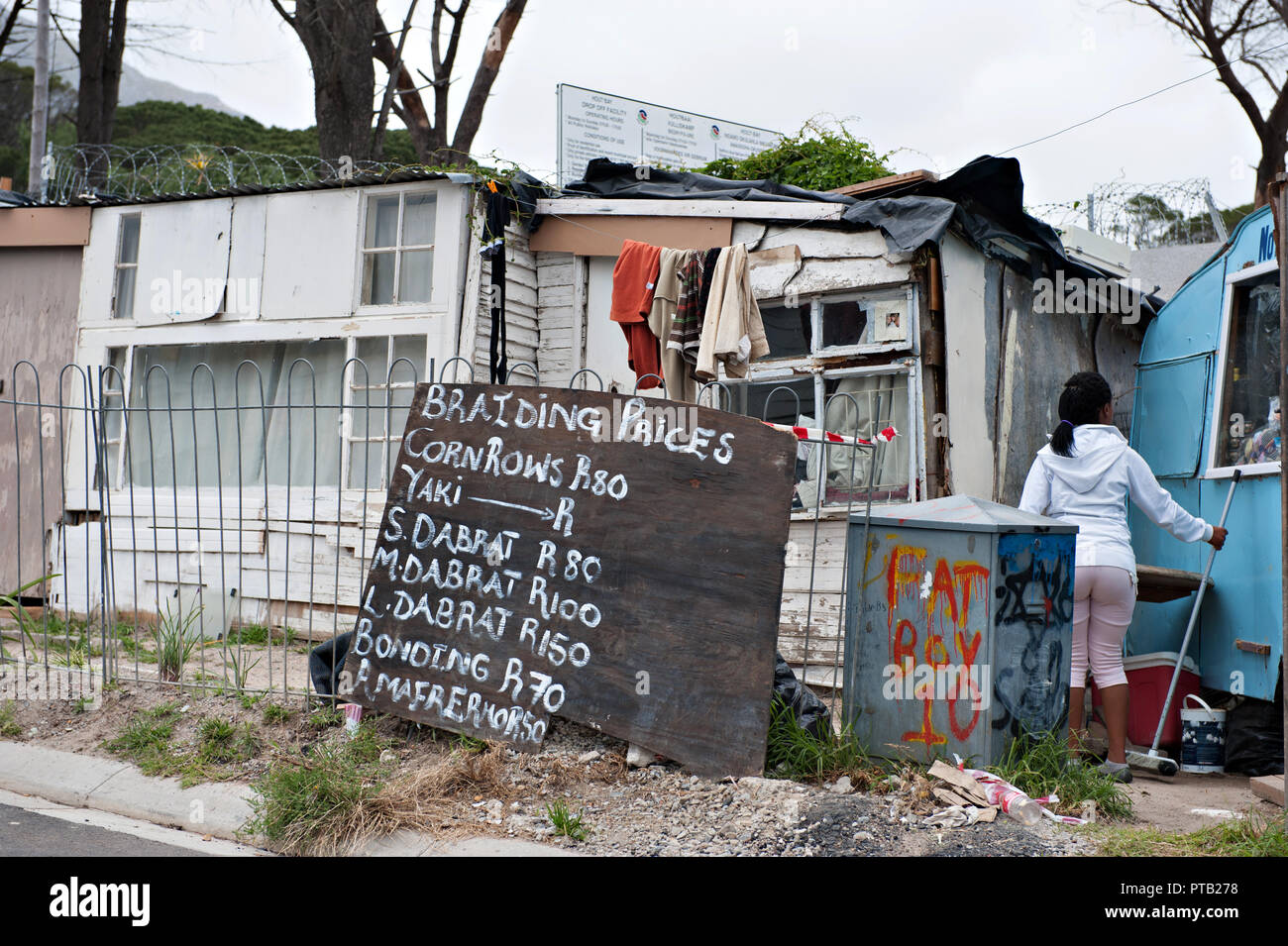 A hair braiding service in the township village of Imizamo Yethu a