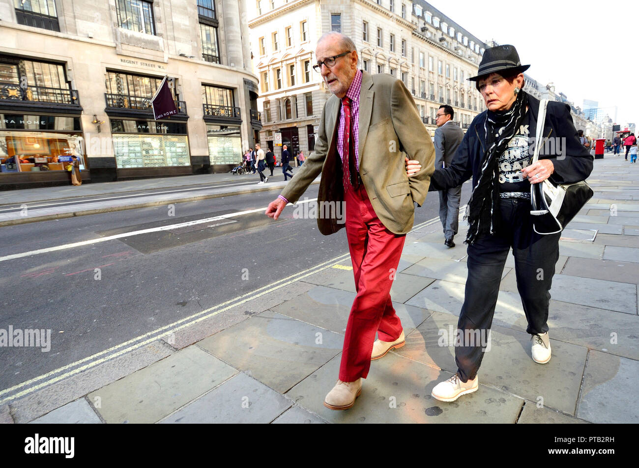 Interestingly-dressed elderly couple, Regent Street, London, England, UK. Stock Photo