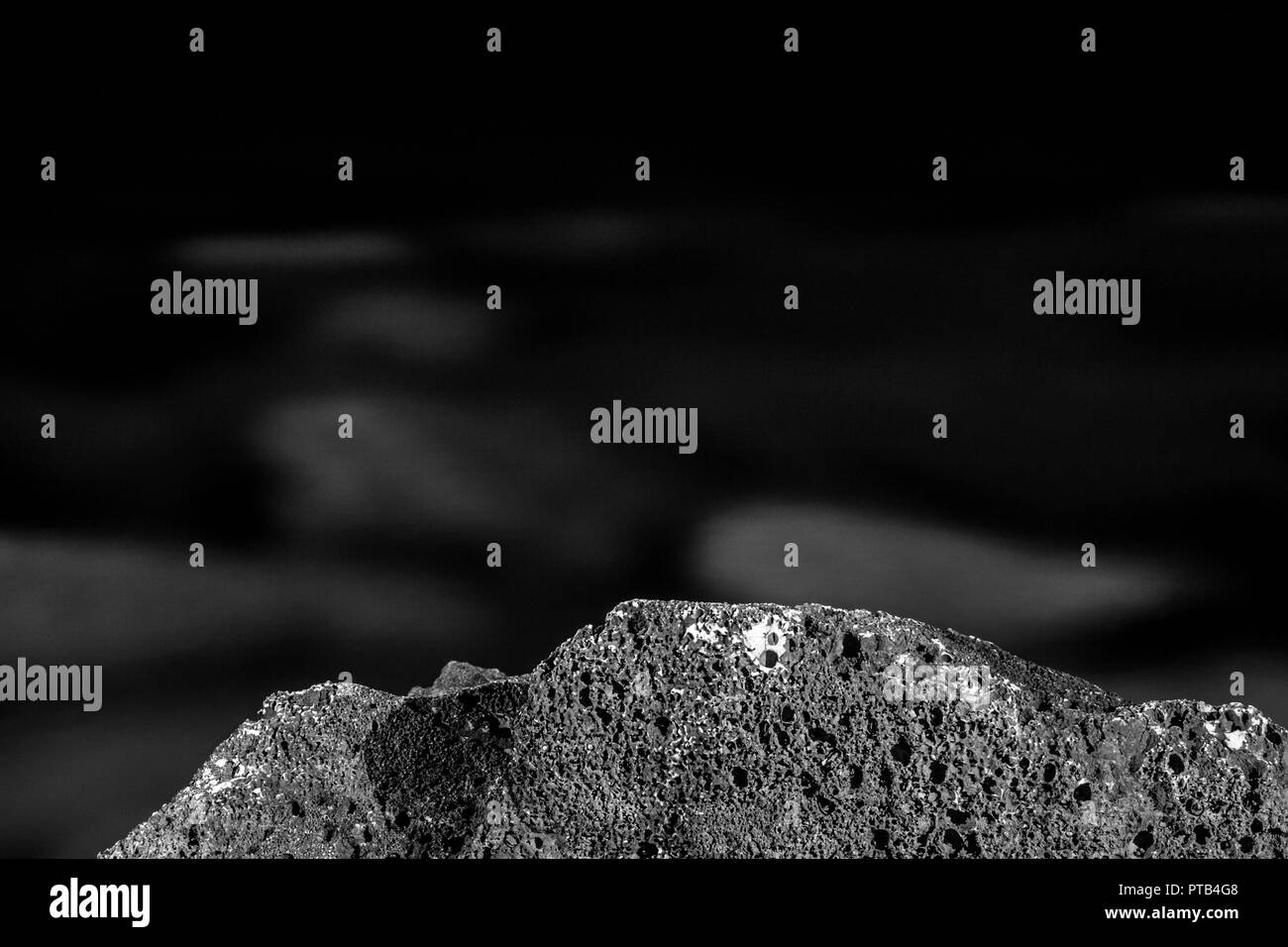 Black and white, monochrome, abstract, night composition of stones. Moonscape. Blackness and atmosphere of calmness in rocky landscape. Stock Photo