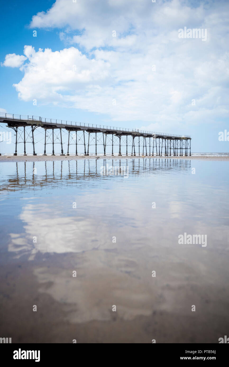 Saltburn Pier, North Yorkshire, reflected in wet sand Stock Photo