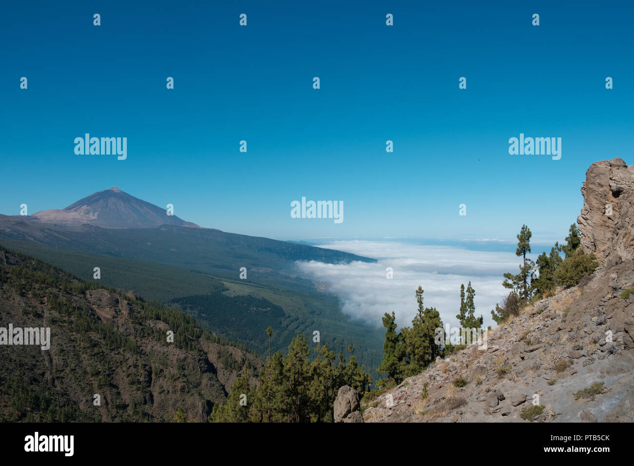 Tenerife mountain landscape with view on Pico del Teide summit above clouds - Stock Photo
