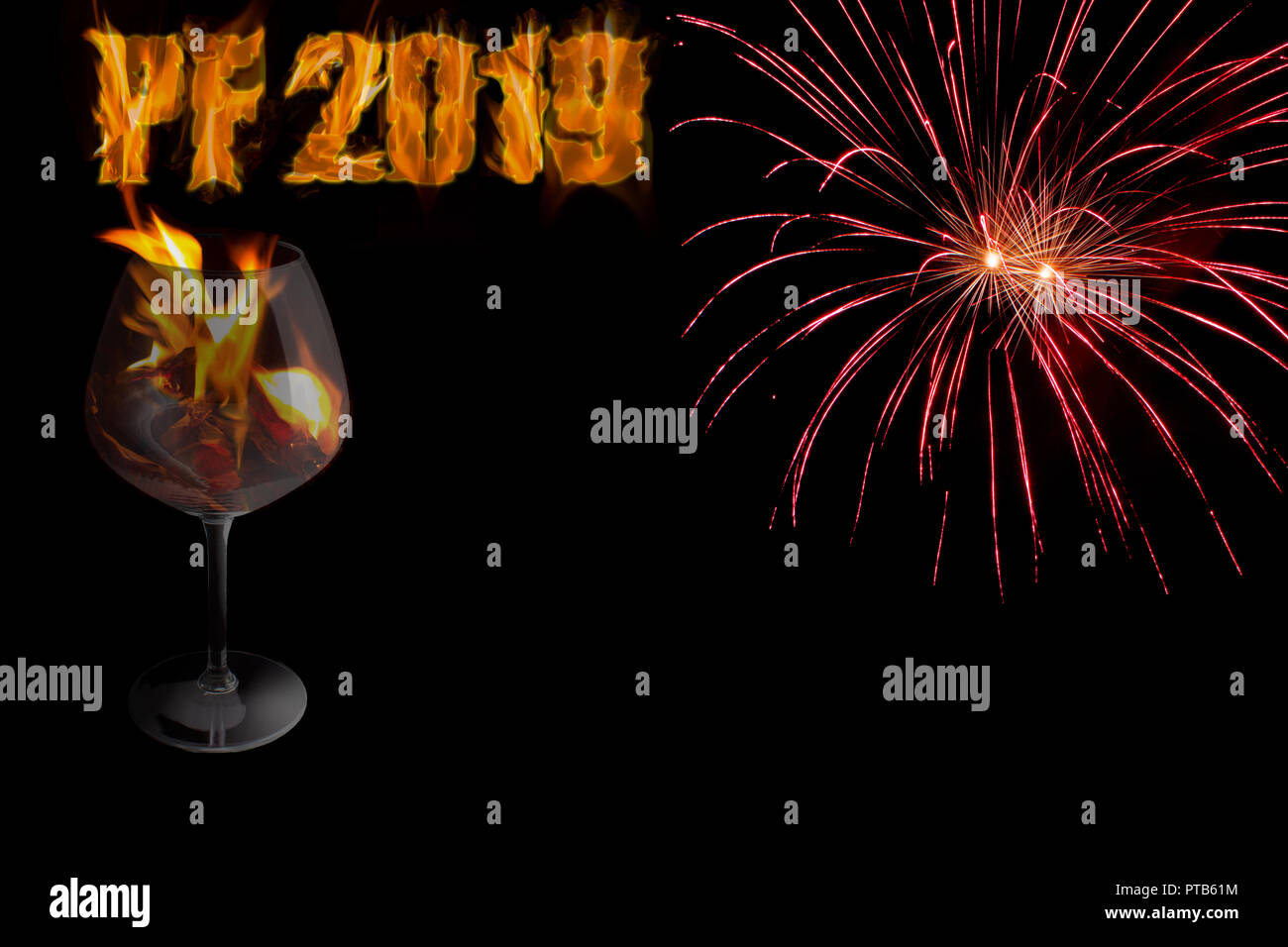 PF 2019 - happy New Year with a glass in a fire and red fireworks on black background with free space for text. Stock Photo