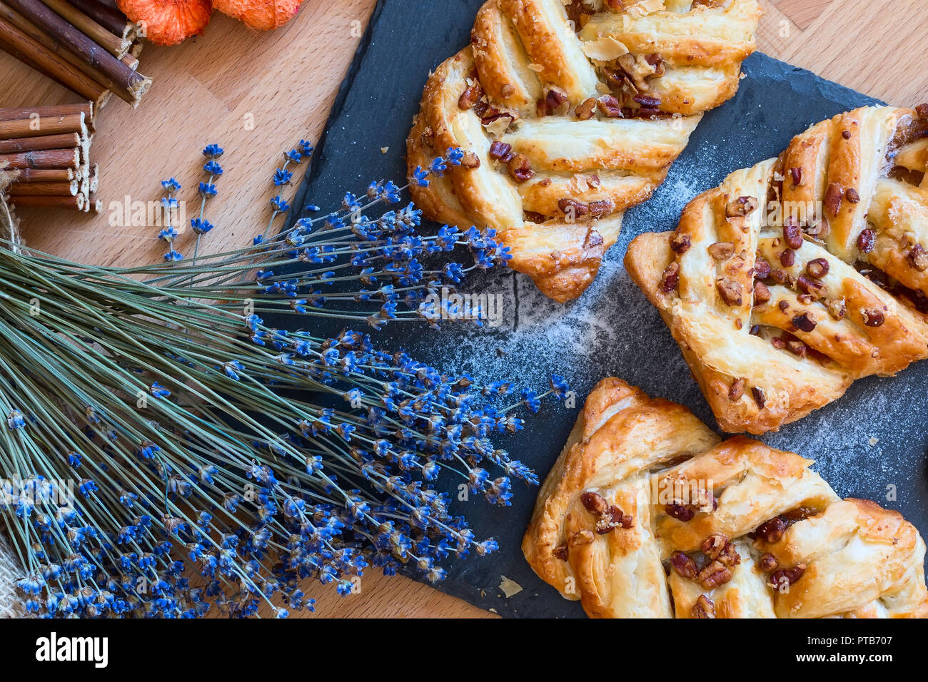 marple and pecan plait pastry sweet food breakfast with lavender flowers Stock Photo