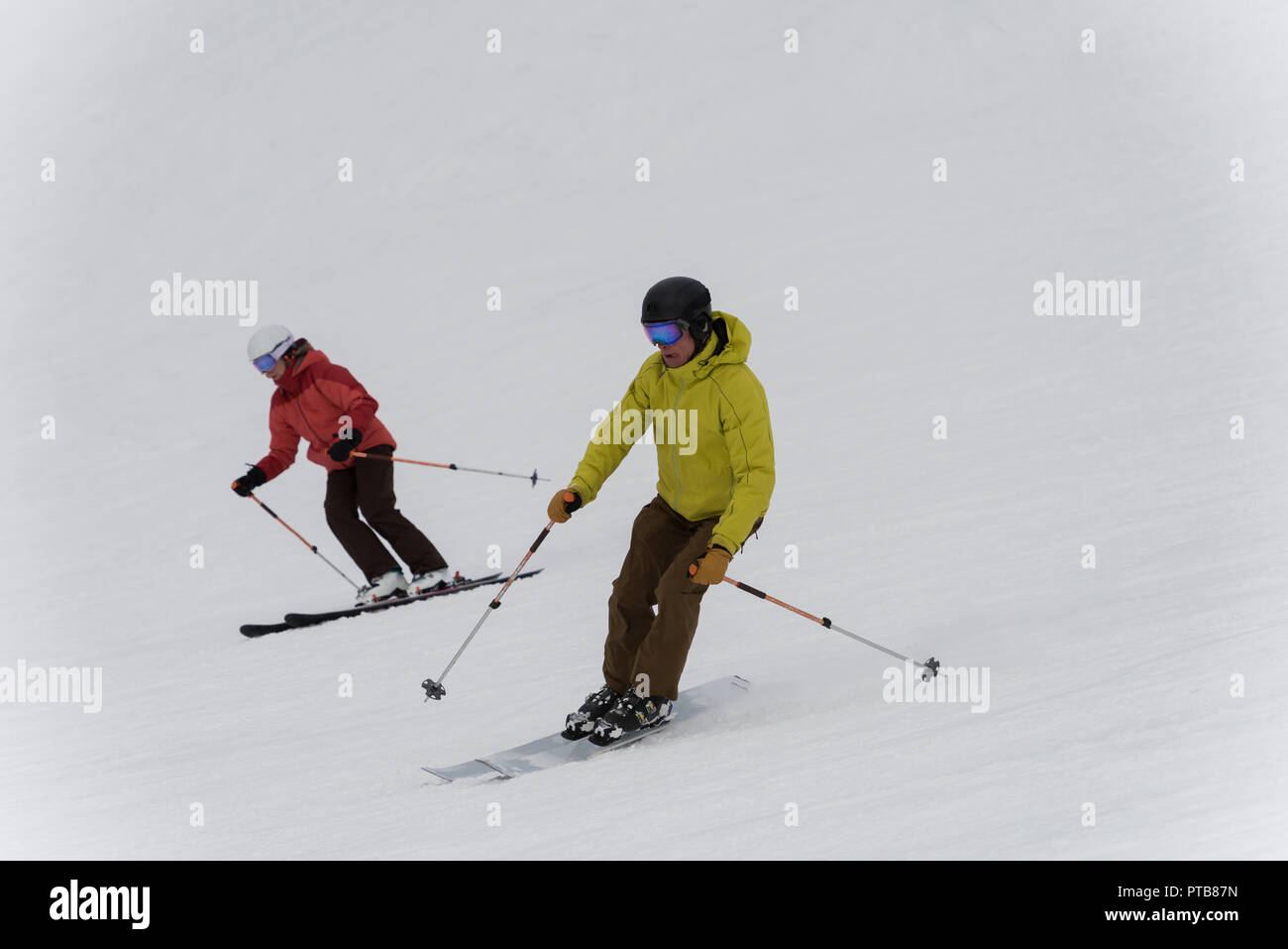 Skier couple skiing on snowy landscape Stock Photo