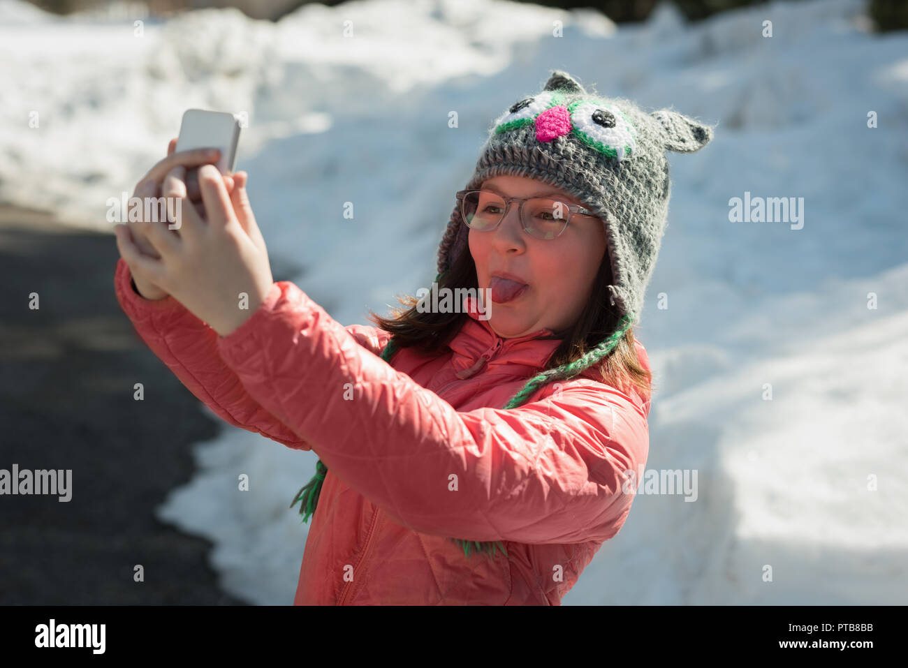 Girl using mobile phone near street Stock Photo