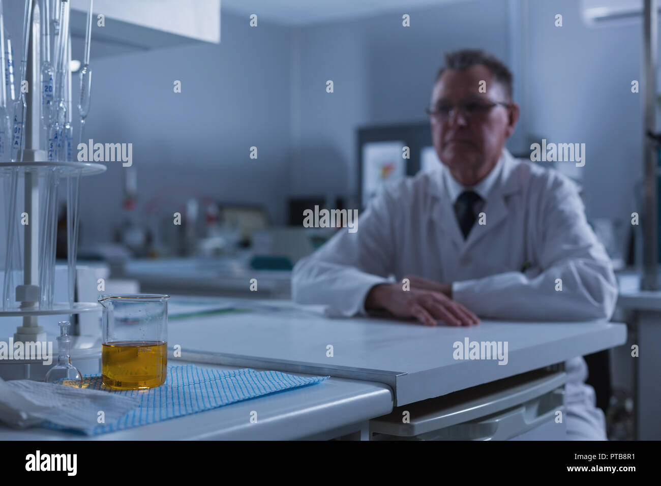 Male scientist sitting at table Stock Photo